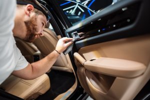 a person performing a car detailing service in burlington