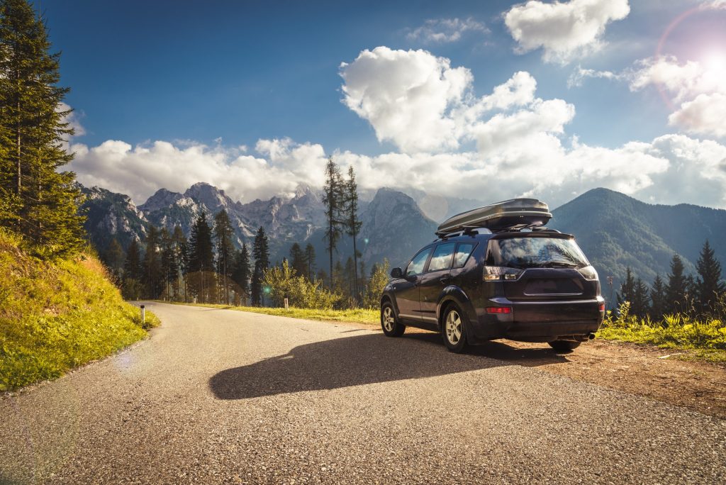 Shiny black car parked under sunlight with deep gloss finish—steps to protect car paint from sun damage