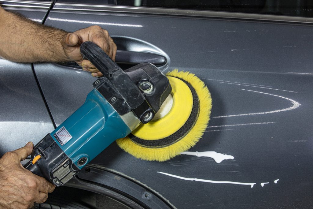 Paint correction and ceramic coating prep work at Spotless Car Spa facility